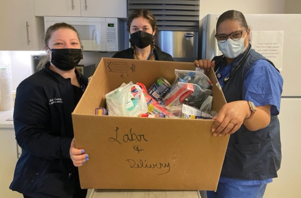 Labor & Delivery staff at Princeton Medical Center displaying their contributions to the annual Heroes Fighting Hunger food drive.